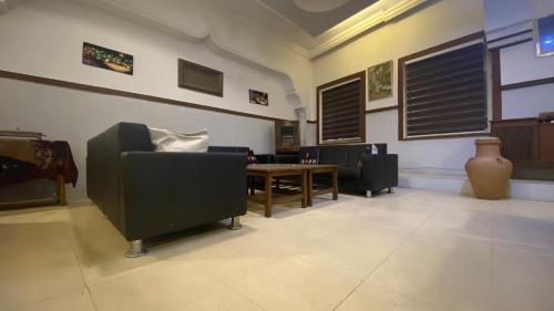 a waiting room with chairs and a table and a vase at New Park Hotel in Amman
