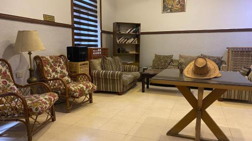 a living room with a table with a hat on it at New Park Hotel in Amman