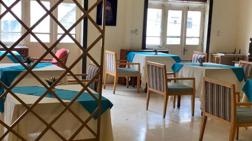 a restaurant with two tables and chairs with blue tables at New Park Hotel in Amman