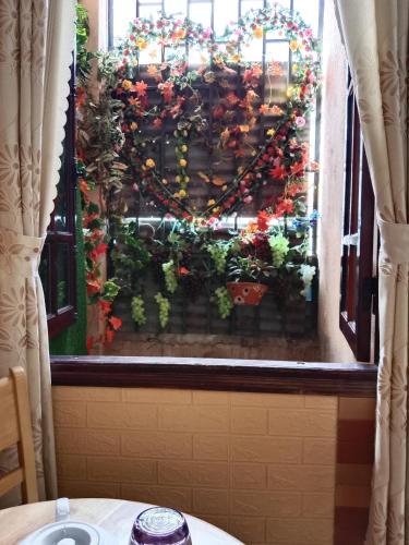 a window with a christmas wreath on it at Nón Lá Guest House in Da Lat