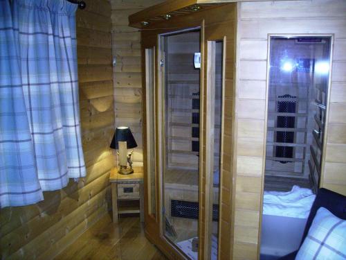 a bathroom with a shower and a table with a lamp at Pheasant Lodge Scottish Borders in Carlisle