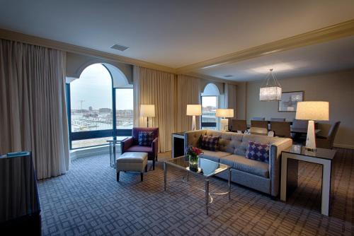 a living room with a couch and a table at The Royal Sonesta Harbor Court Baltimore in Baltimore