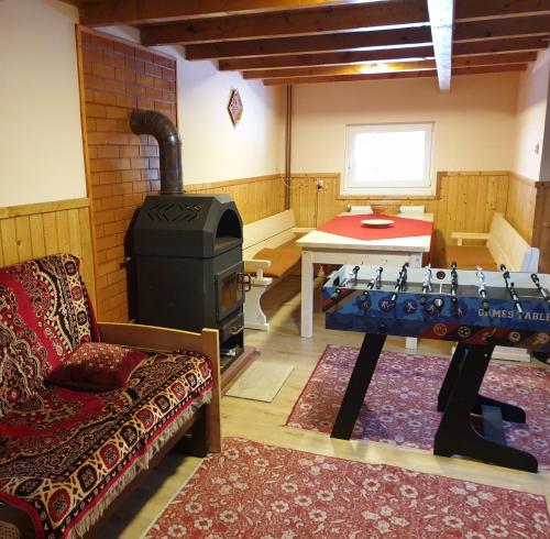 a living room with a wood stove and a couch at Green House in Gheorgheni