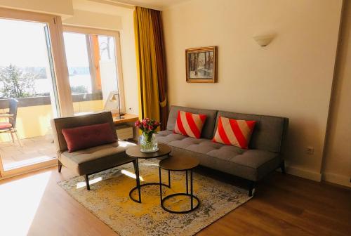 a living room with a couch and a table at Schwarzwaldhotel Oberwiesenhof in Seewald