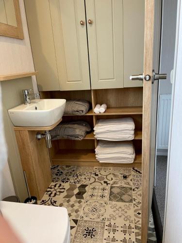 a small bathroom with a sink and a toilet at 5 Lake View, Barrow, Clitheroe - in the heart of the Ribble Valley in Pendleton