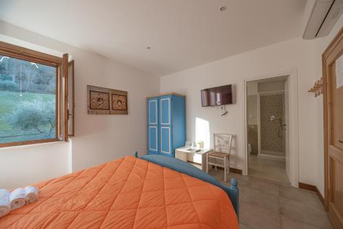 a bedroom with an orange bed and a desk at Locanda Orvieto Agriturismo in Orvieto