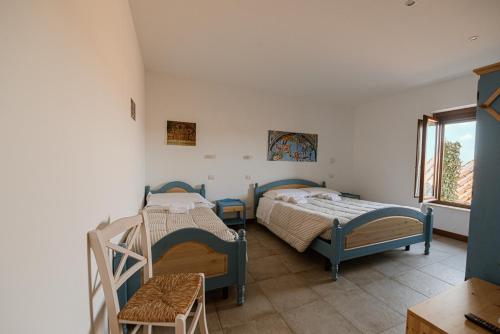 a bedroom with two beds and a window at Locanda Orvieto Agriturismo in Orvieto