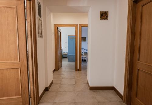 a hallway with two doors and a tile floor at Locanda Orvieto Agriturismo in Orvieto