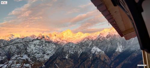 a view of a mountain range with snow on it at Mountain Rover Auli Resort in Joshīmath