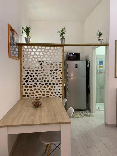 a dining room with a table and a refrigerator at La Terrazza della Nonna in Palermo