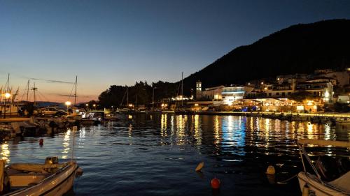 a harbor at night with boats in the water at Lina A & M in Neo Klima