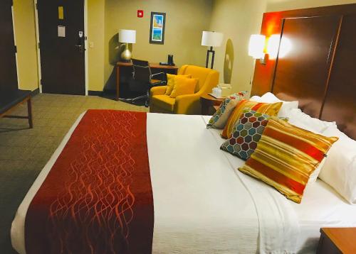 a hotel room with a bed with pillows on it at Comfort Inn, Erie - Near Presque Isle in Erie
