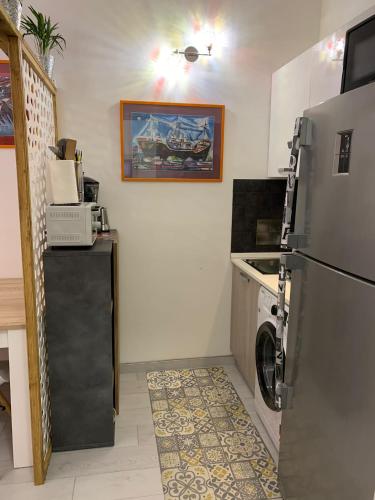 a kitchen with a refrigerator and a washer and dryer at La Terrazza della Nonna in Palermo