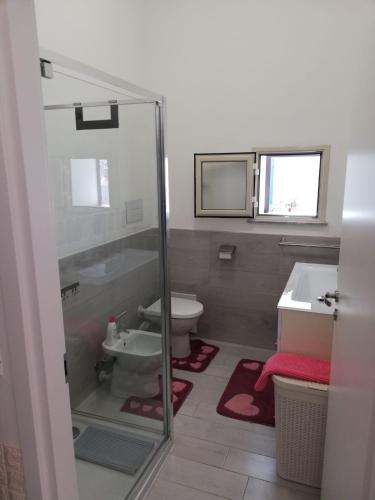 a bathroom with a toilet and a sink at La Terrazza della Nonna in Palermo