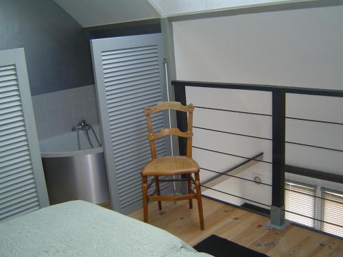 a bedroom with a chair and a bath tub at Studio Etables sur mer in Étables-sur-Mer
