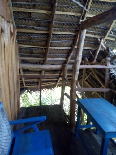 a blue picnic table and a blue bench in a cabin at Mermaid Cabana and Tree Houses in Tangalle
