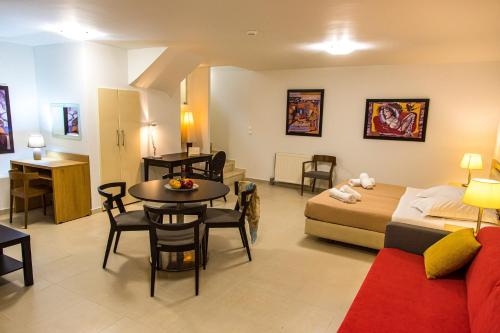 a living room with a bed and a dining room at Thealos Village aparthotel Lefkada in Lygia