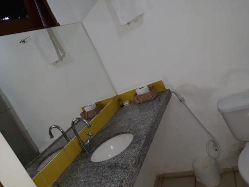 a bathroom with a sink and a toilet at Hotel Pousada Summer Way in Aquiraz