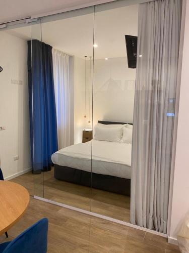 a bedroom with a bed and a glass wall at Nu House Rooms & Apartments in Cassano delle Murge