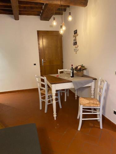 a dining room with a white table and chairs at Home sweet home in San Gimignano