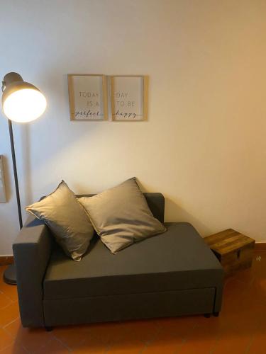 a couch sitting in a living room with a lamp at Home sweet home in San Gimignano