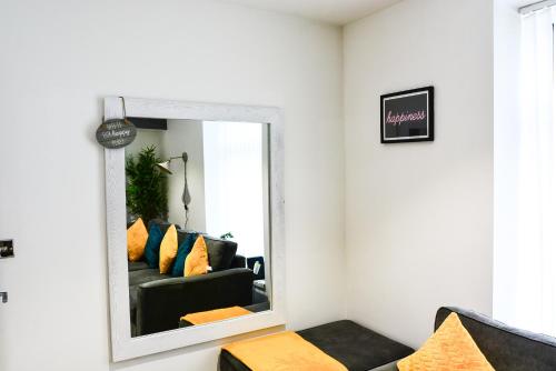 a mirror in a living room with a black couch at Skyline hanover free parking in Swansea