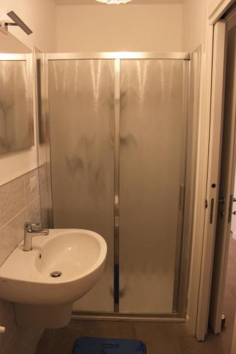 La salle de bains est pourvue d'une douche et d'un lavabo. dans l'établissement Appartamento Torre Matilde, à Viareggio