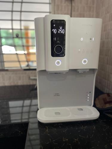 a white coffee machine with a control panel at Homestay Seri Pangkor in Pangkor
