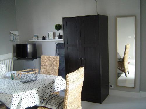 a dining room with a table and chairs and a cabinet at Studio Etables sur mer in Étables-sur-Mer