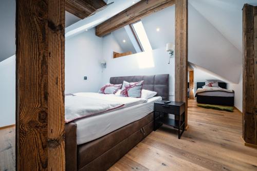 a bedroom with a bed and a large window at Villa Ambach in Oetz