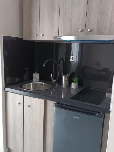 a kitchen with a sink and a counter top at Secret Garden Hotel in Maleme