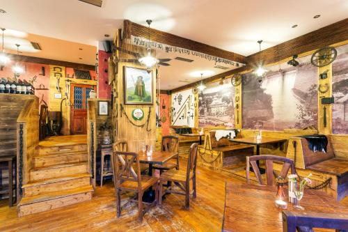 a restaurant with wooden floors and tables and chairs at Wellness Hotel Grand in Špindlerův Mlýn