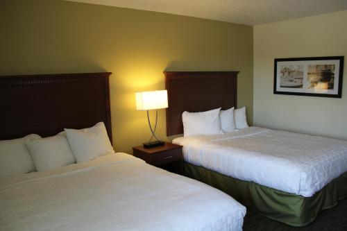 A bed or beds in a room at Nichols Inn & Suites