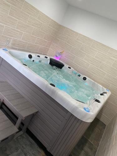 La salle de bains carrelée est pourvue d'un bain à remous. dans l'établissement Le Paradise, à Ville-le-Marclet