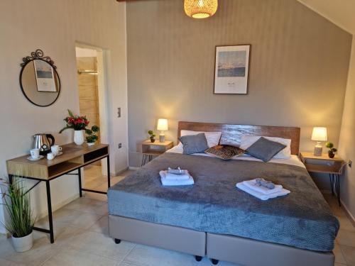 a bedroom with a large bed with two towels on it at Secret Garden Hotel in Maleme