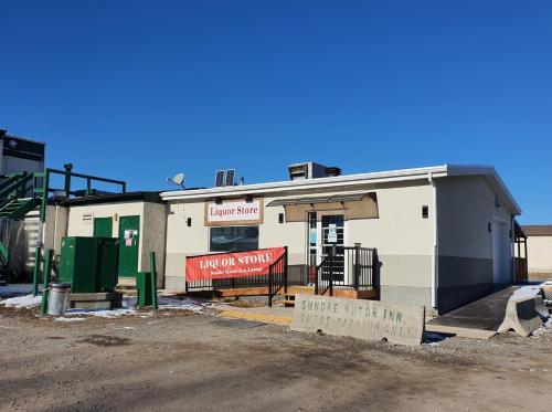 a small white building with a sign in front of it at Sundre Motor Inn in Sundre