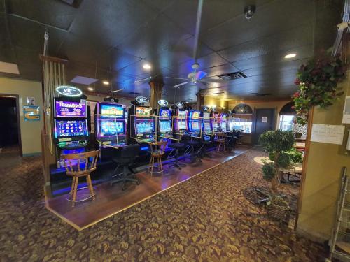 a bunch of slot machines in a room with chairs at Sundre Motor Inn in Sundre