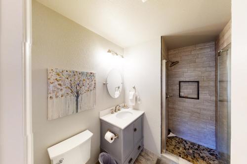 a white bathroom with a sink and a shower at Crazy Horse Condo in Edwards