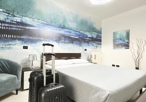 a hotel room with a bed and a suitcase at Skyline in Civitavecchia