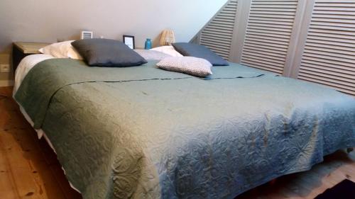 a bed with two pillows on it in a bedroom at Studio Etables sur mer in Étables-sur-Mer