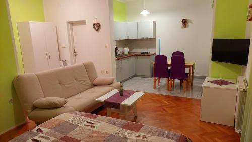 a living room with a couch and a kitchen at IstraNova Apartments in Rovinj