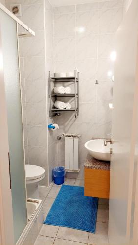 a white bathroom with a sink and a toilet at IstraNova Apartments in Rovinj