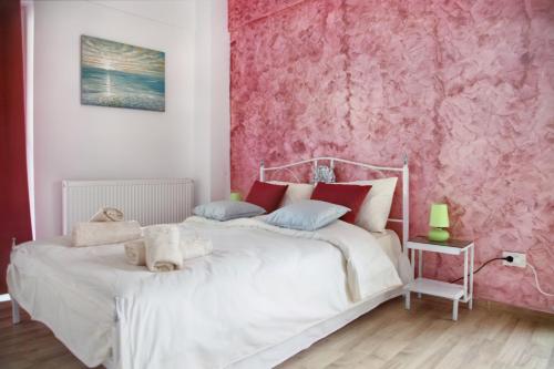 a bedroom with a pink wall and a bed at Luxury Downtown Apartment in Cluj-Napoca
