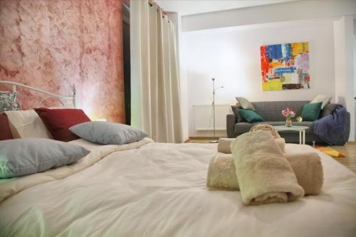 a bedroom with a large white bed with pillows at Luxury Downtown Apartment in Cluj-Napoca