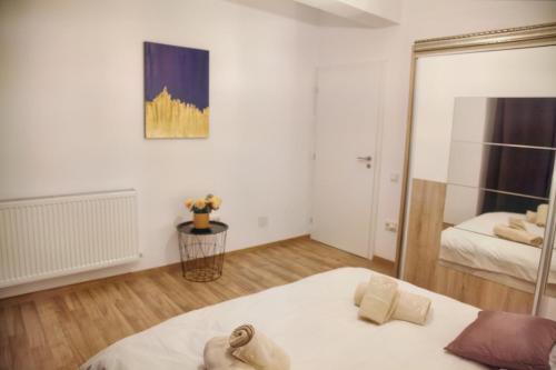 a bedroom with a bed and a mirror at Luxury Downtown Apartment in Cluj-Napoca