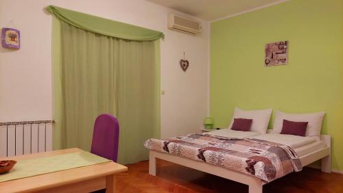 a bedroom with a bed and a wooden table at IstraNova Apartments in Rovinj