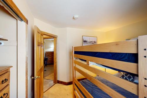 a bedroom with a bunk bed and a hallway at Bellflower Trout House in Vail