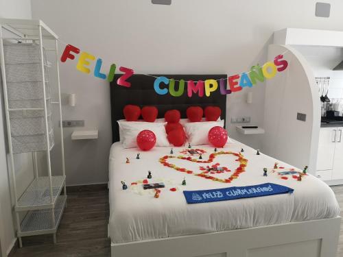 a bed with a happy birthday sign on top of it at ERES EMÉRITA "Apartamentos & Suites" in Merida