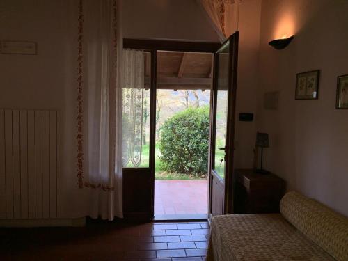 a living room with a door open to a patio at Ca' le Suore in Cagli