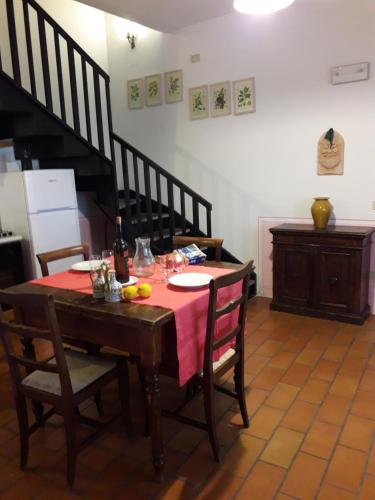 a dining room with a table with a red table cloth at Ca' le Suore in Cagli